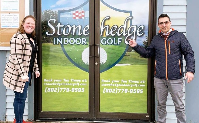 Ashley Bride and Matt Russo from the United Way posing in front of Stonehedge Indoor Gold venue.