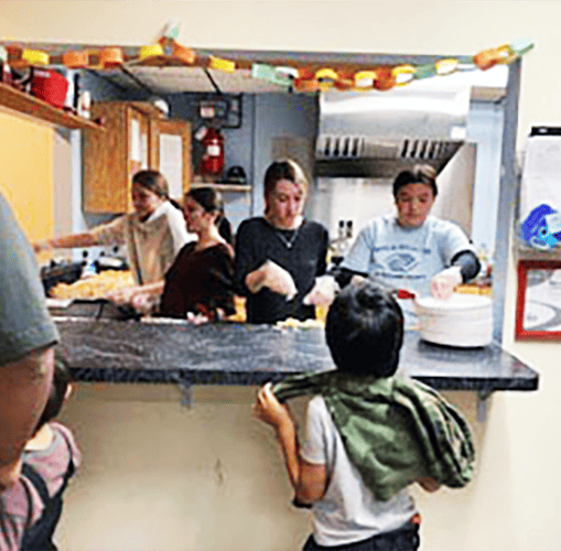 Boys and girls service food at fun event at Boys and Girls Club of Rutland County.