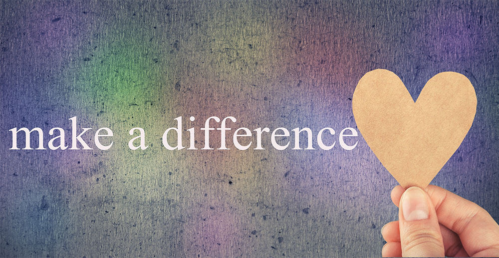 Make a difference text and hand holding heart cutout