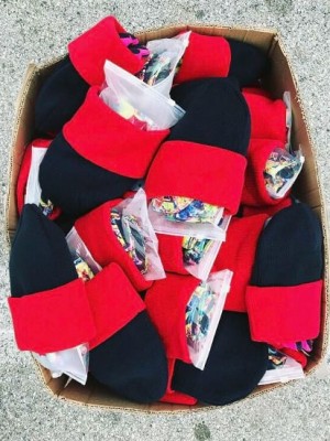 Box of children's hats filled with gloves and mittens.